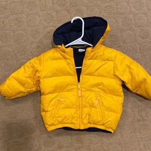 reversible puffer jacket, unisex in style and color.